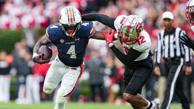Tank Bigsby (4) stiff arms defender during the game between Auburn and Western Kentucky at Jordan-Hare Stadium. Austin Perrymann/AU Athletics